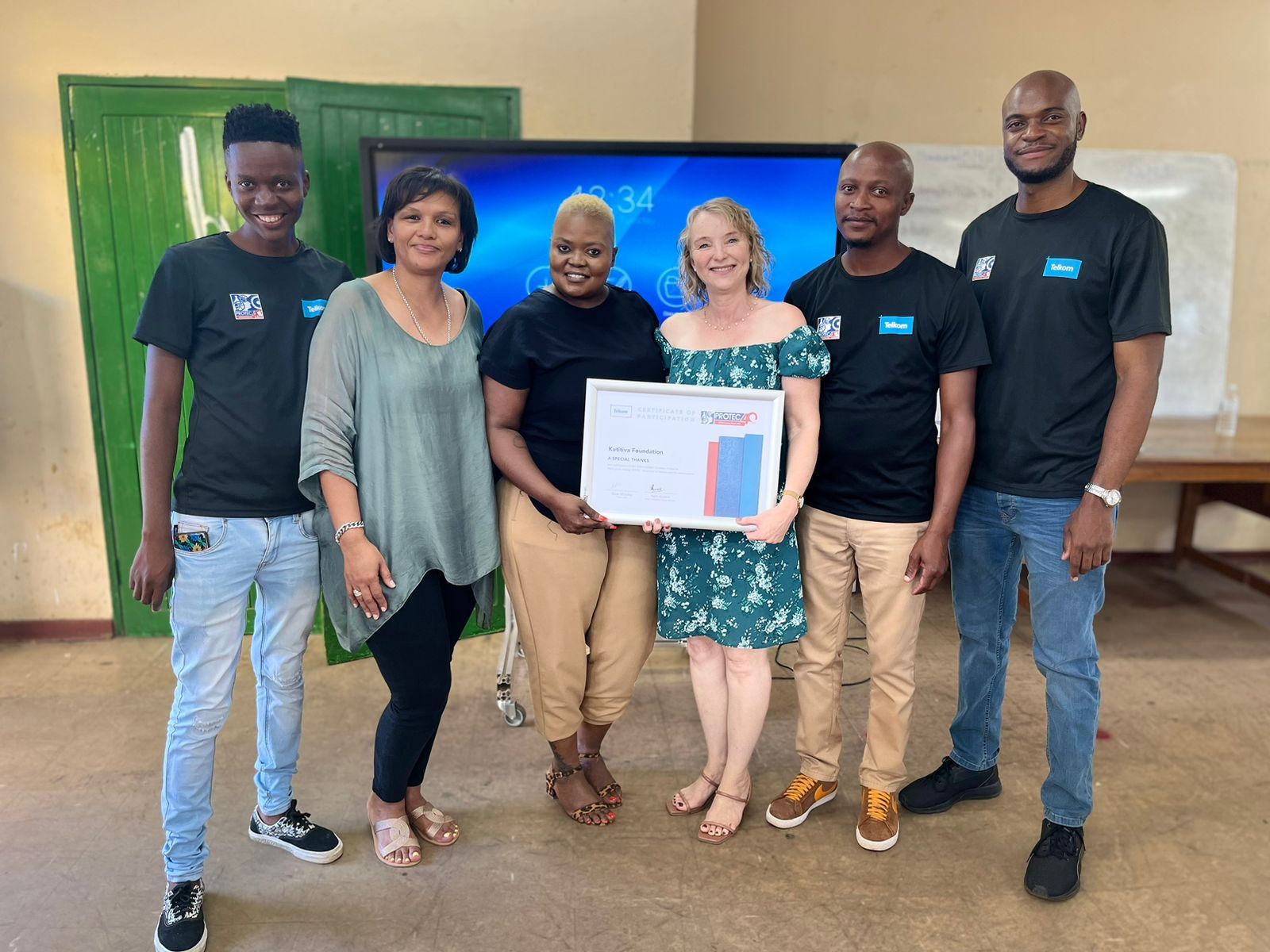 Kutitiva team and programme partners at a certificate handover